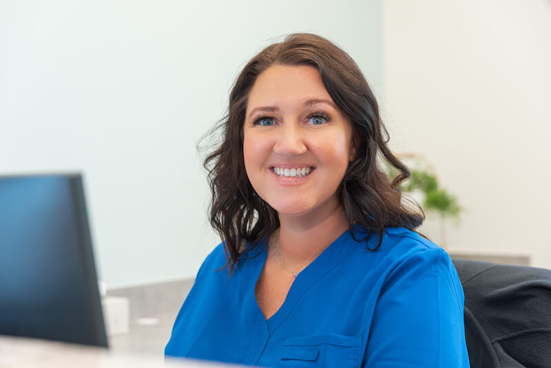 Patient Care Coordinator helping patients with fanancing and dental insurance at Magnolia Ridge Dentistry.